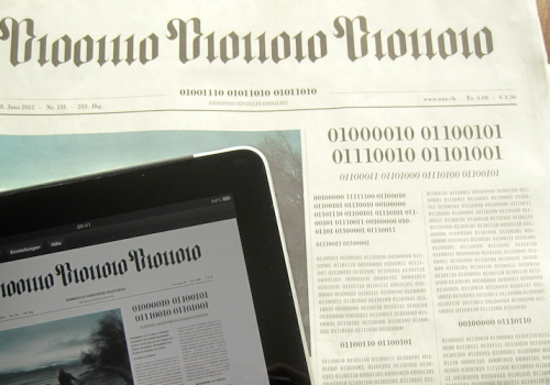 Swiss newspaper NZZ frontpage printed in binary code, human readable text on iPad (adapted) (Image by visualpun.ch [CC BY-SA 2.0] via Flickr)