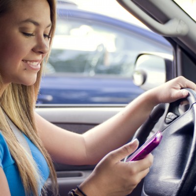 A teen girl texting while driving (Image by CDC/Amanda Mills [CC0 Public Domain], via Freestockphotos.biz)