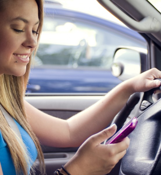 A teen girl texting while driving (Image by CDC/Amanda Mills [CC0 Public Domain], via Freestockphotos.biz)