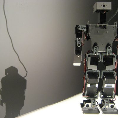 robot and shadow (adapted) (Image by Hsing Wei [CC BY 2.0] via Flickr)