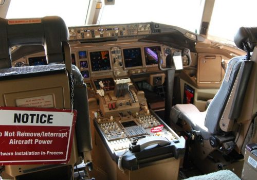 Boeing 777 cockpit, note software update in progress... (adapted) (Image by Bill Abbott [CC by 2.0] via flickr)