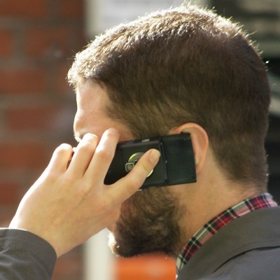 Man_speaking_on_mobile_phone (Image by Tim Parkinson [CC by 2.0] wikipedia commons