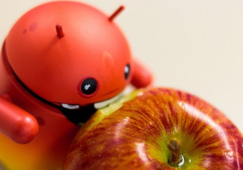 Android eating Apple (adapted) (Image by Aidan [CC BY 2.0] via Flickr)