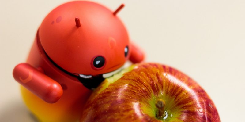 Android eating Apple (adapted) (Image by Aidan [CC BY 2.0] via Flickr)