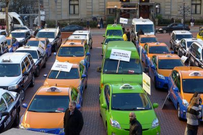 Taxi Cabs vs Uber (adapted) (Image by Aaron Parecki [CC BY 20] via Flickr)