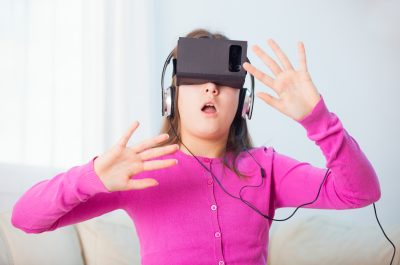 Girl Playing Video Game With Virtual Reality Headset