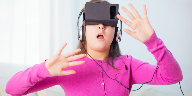 Girl Playing Video Game With Virtual Reality Headset