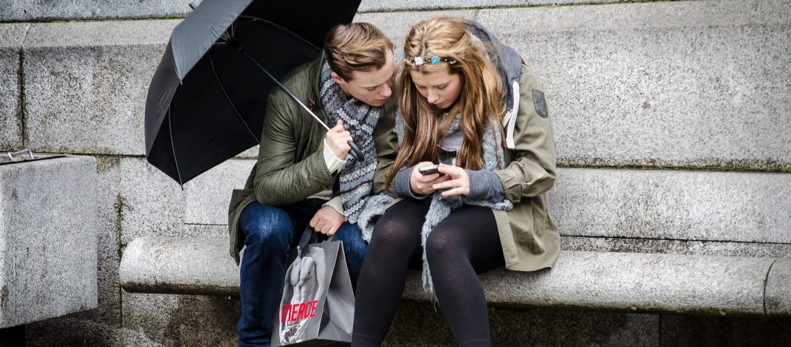 Texting in the rain (adapted) (Image by Garry Knight [CC BY 2.0] via Flickr)