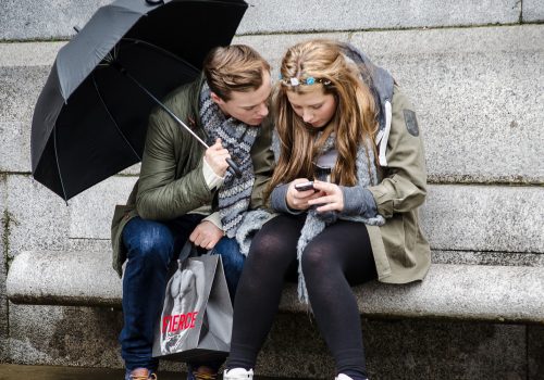 Texting in the rain (adapted) (Image by Garry Knight [CC BY 2.0] via Flickr)