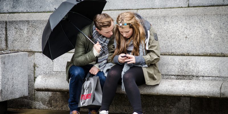 Texting in the rain (adapted) (Image by Garry Knight [CC BY 2.0] via Flickr)