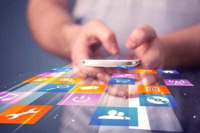 App Store Man holding smart phone with colorful application icons comming out