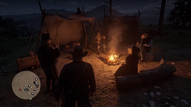 Im nächtlichen Lager feiern mehrere Personen um ein Lagerfeuer.