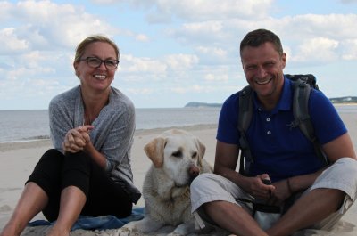 Dogsharing-Plattform Titelbild / Mann und Frau mit Hund am Strand