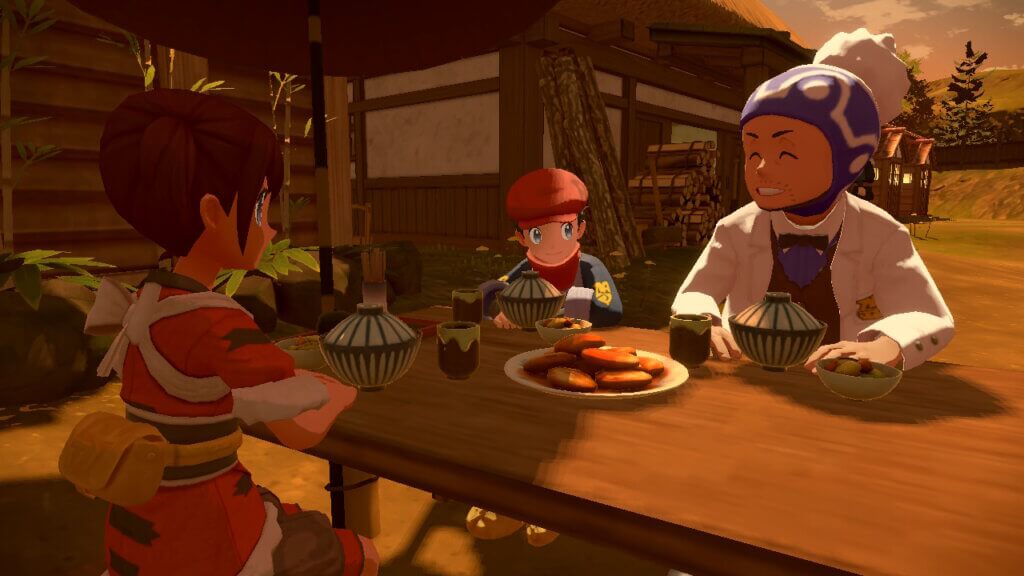Der Hauptcharakter von Pokémon-Legenden: Arceus sitzt zusammen mit zwei anderen an einem Tisch und isst Kartoffel-Mochi