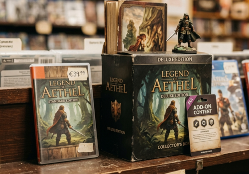 > A store shelf displaying two versions of the same game side by side: a slim standard edition case on the left, and a bulky deluxe edition box on the right stuffed with extras — an art book poking out, a figurine on top, a DLC card leaning against it. A small handwritten price tag hangs from each. The shelf is slightly dusty, the lighting is warm and practical like a real game store. No logos, no brand names visible. Photographic style. Square format 1:1 aspect ratio, output as JPEG, file size under 1MB.